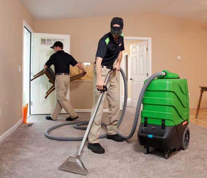 two SERVPRO employees cleaning house after a water loss