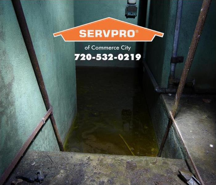 A basement is shown flooded with water.