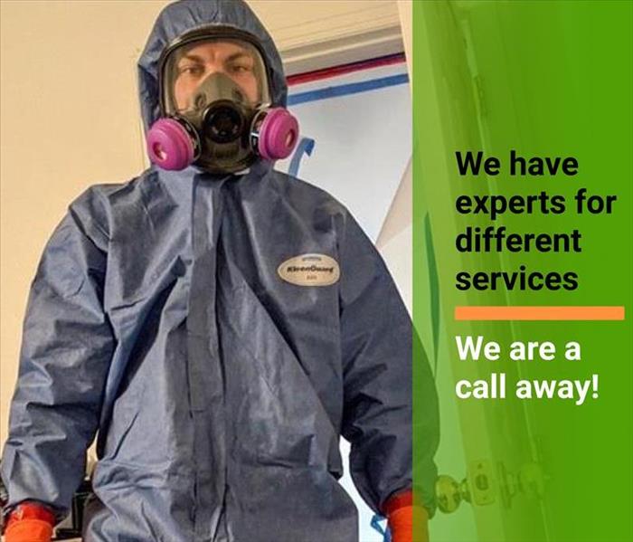 man in PPE suit with we are a call away text